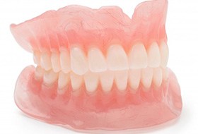 Lady presents viewer with dentures