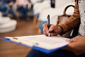 Patient filling out forms in lobby
