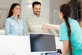 Man and woman checking in at front desk