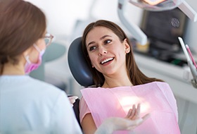 Dentist talking to female patient