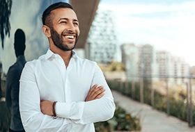 a smiling man wearing a white dress shirt