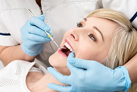 Woman receiving oral cancer screening