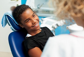 Smiling teen girl in dental chair