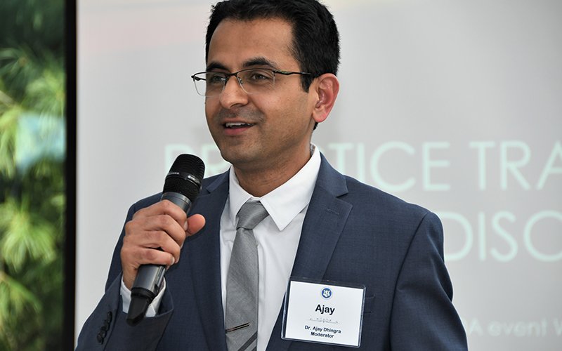 Dr. Ajay holding microphone