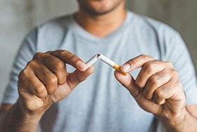 Break bad habits like smoking to protect your new dental implants