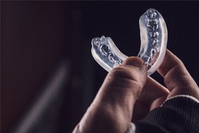 Patient holding clear mouthguard