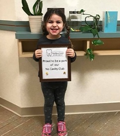 Patient holding award certificate