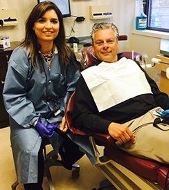 Dentist and patient in dental exam room