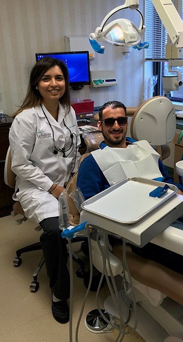 Dentist and dental patient in exam room