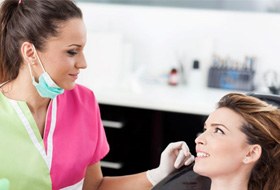 Patient and dental team member conversing with each other