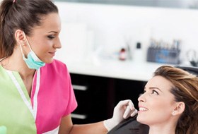 Patient and dental team member conversing with each other