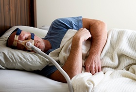 Man sleeping with CPAP system