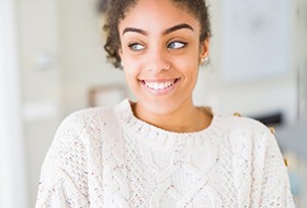 a woman smiling after undergoing teeth whitening