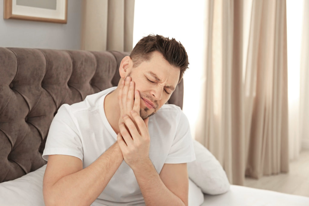 Man is in pain because he has a dental emergency.