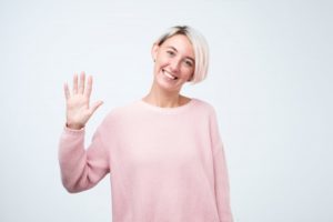 Smiling woman waves to her West Hartford dentist in COVID-19