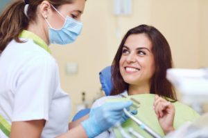 Patient asking her West Hartford dentist about oral hygiene and health