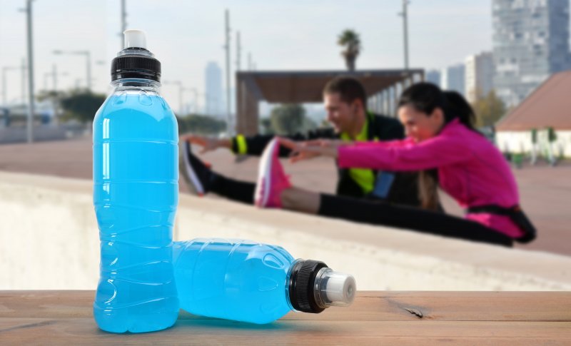 Sports drinks next to stretching couple