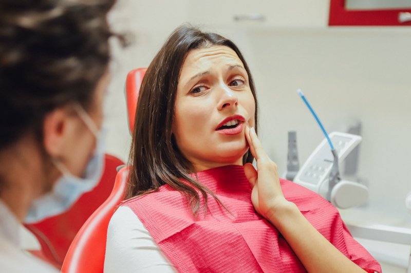 Woman at dentist with loose tooth