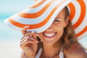 woman smiling after getting porcelain veneers