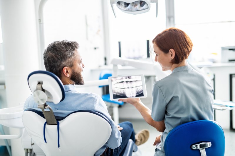 person learning about the benefits of porcelain veneers