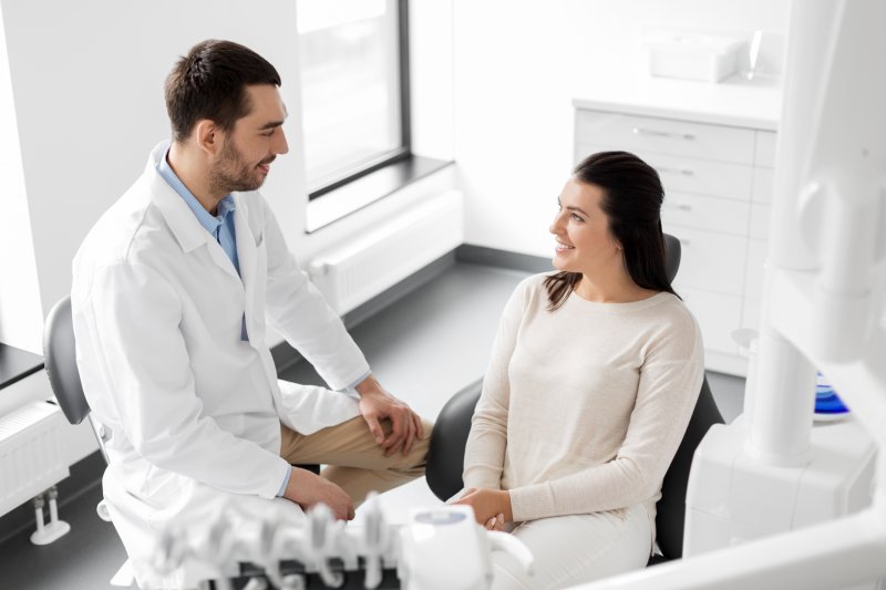 patient learning what your teeth say about you from dentist