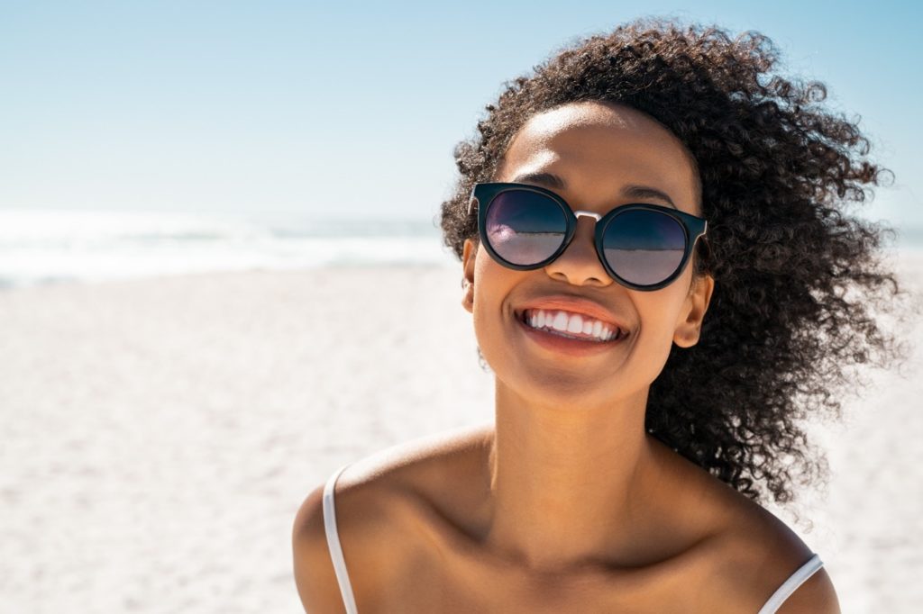 closeup of patient smiling after receiving dental implants  