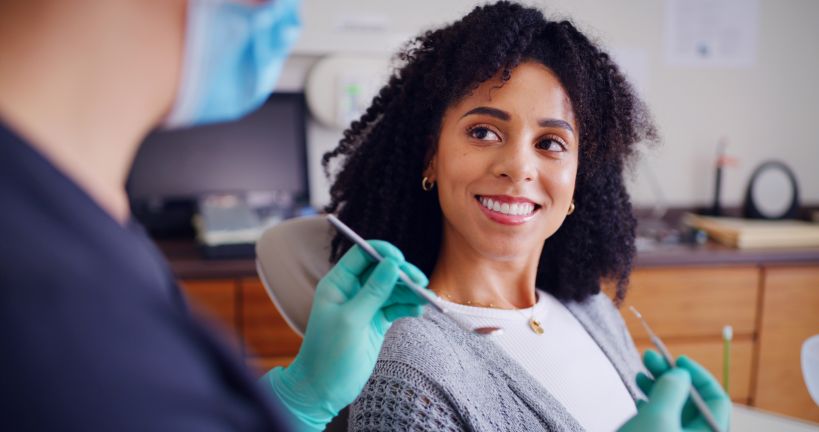 A woman smiling at the dentist